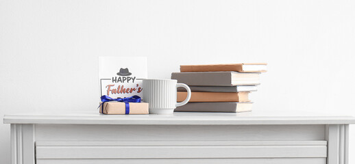 Fototapeta na wymiar Greeting card for Happy Father's Day with cup, books and gift