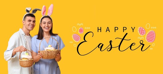 Happy young couple with bunny ears and Easter baskets on yellow background. Easter greeting banner