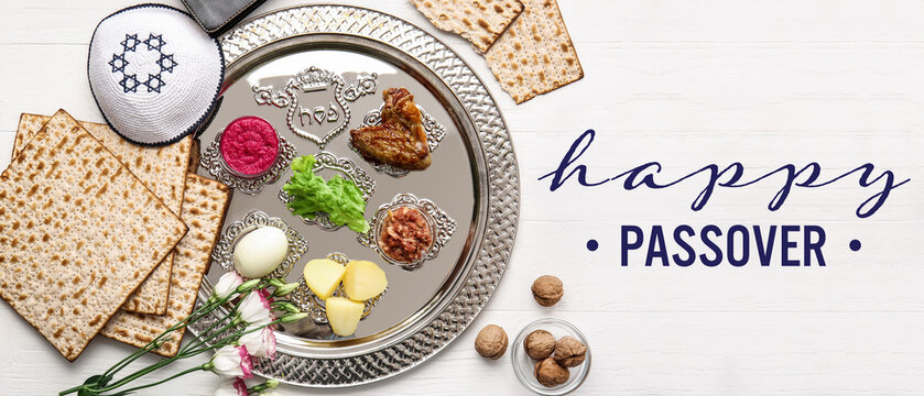 Passover Seder plate with traditional food and Jewish cap on table