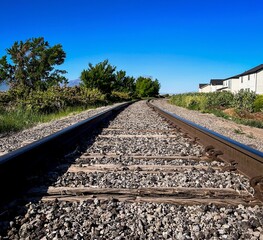 Train Tracks Behind a Neighborhood Disappearing into the Distance