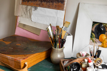 Brushes and Weathered Palette in the Artist's Studio Workspace