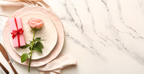 Beautiful table setting for Valentine's Day dinner on light background with space for text