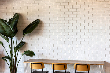 Cafe Interior Design with White Brick Wall, Empty Tables, and Chairs