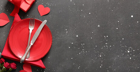 Beautiful table setting for Valentine's Day dinner on dark grunge background with space for text