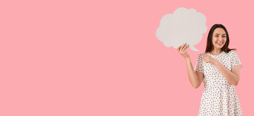 Happy young woman holding blank speech bubble on pink background with space for text