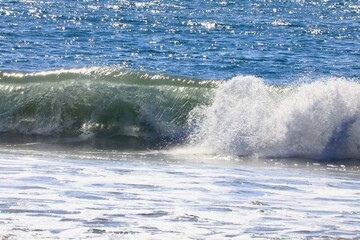 Large wave splashing in blue sea