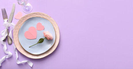 Beautiful table setting for Valentine's Day dinner on lilac background with space for text