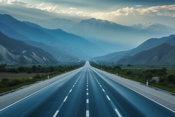 The wide blue highway in front of mountains.