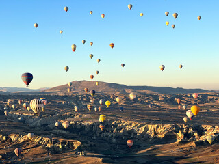 Colorful flying air balloons in sky at sunrise in Anatolia. Vacations in beautiful destination in Goreme, Turkey