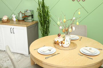 Interior of modern kitchen with table served for Easter celebration