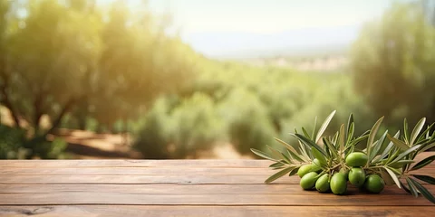 Fototapeten Vintage wooden table and green olive field background for displaying products, with blurred olive tree design. © Vusal