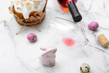 Composition with wine glass, Easter eggs and cake on light background, closeup