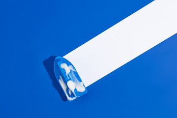 On a blue background, a brush with soap bubbles trailing a white stripe. Simulates stain cleaning....
