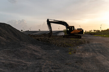 Development in progress, excavator on a construction site