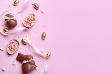 Chocolate bunny, Easter eggs and ribbon on pink background
