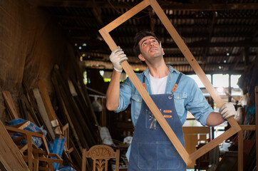 Carpenter working at his carpentry shop. Eyesight is utilized to ensure accuracy.