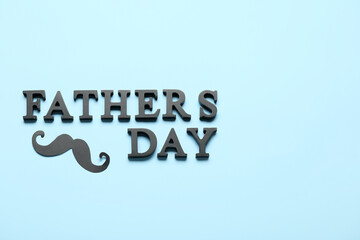 Text HAPPY FATHER'S DAY with paper mustache on blue background