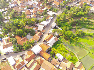Fototapeta na wymiar Top view of Dense Housing. Aerial Photography. Aerial panorama over the dense housing complex. Shot from a drone flying 200 meters high. Cikancung, Indonesia