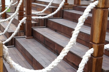 outdoor wooden staircase with big rope handle