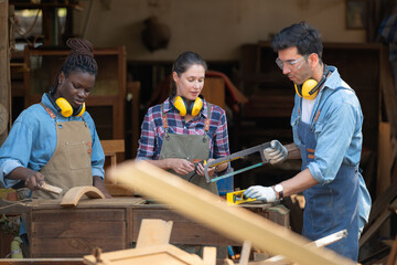 Carpenter and his assistant working together in a carpentry workshop