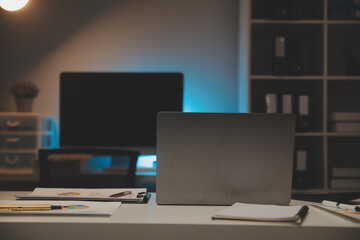 Laptop and paperwork on conference table