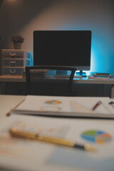 Laptop and paperwork on conference table