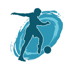 Silhouette of a female soccer player kicking a ball. Silhouette of a football player woman in action pose.