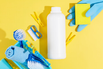 House cleaning product on yellow background with a white bottle mockup for detergents product. The...