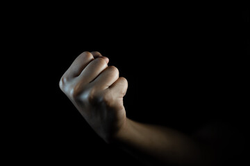 fist, Hand gesture. man clenched fist, ready to punch, isolated on black, close-up, copy space