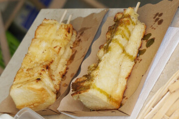 two bread grilled on paper box