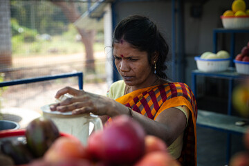 A lady in India makes juice and sells it.
