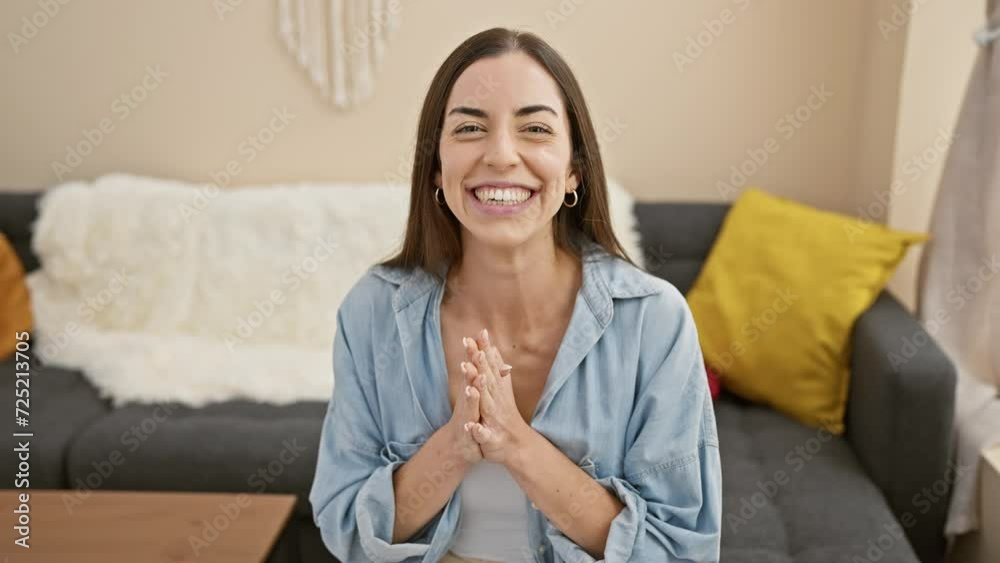 Canvas Prints Young beautiful hispanic woman smiling confident sitting on sofa at home