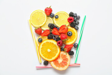Composition with straws and fresh ingredients for lemonade on white background