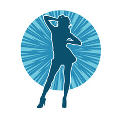 Silhouette of a female dancer wearing mini skirt in action pose. Silhouette of a slim woman dancing happily.