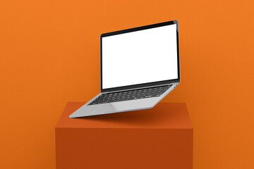 laptop computer with blank screen and orange background