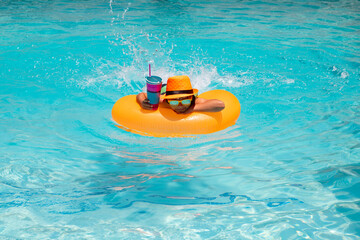 Fototapeta premium Kids summer relax. Kid boy in swim pool swimming on inflatable ring. Kid swim with orange float. Water toy, healthy outdoor sport activity for children. Kids beach fun. Fashion summer kids hat.