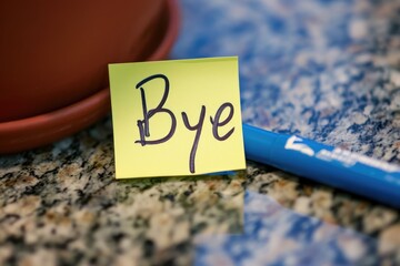 Bye message written on a post-it note
