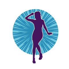 Silhouette of a female dancer wearing mini skirt in action pose. Silhouette of a slim woman dancing happily.