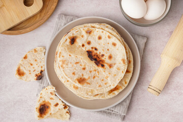 Plate of tasty pita bread on white background