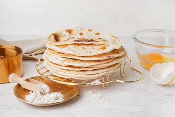 Grid of tasty pita bread and ingredients on white background