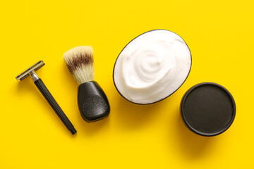 Set of shaving accessories on yellow background