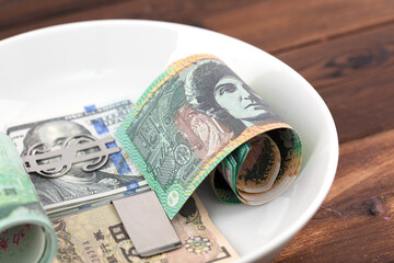 Several international banknotes on a plate