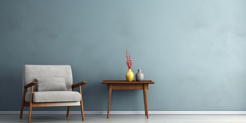 Grey-walled room featuring a blue armchair and wooden table.