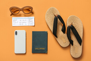 Composition with beach accessories, mobile phone, passport and ticket on color background