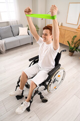 Sporty young man in wheelchair training with stretching band at home