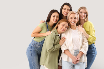 Obraz premium Beautiful hugging women on grey background