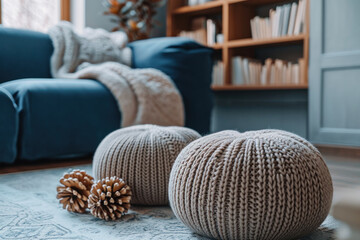 Cozy interior with knitted pouf and sofa in stylish living room. Home comfort and design.
