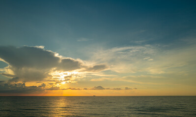 Dramatic sunset and cloudy sky. sea. Calm sea with cloudy sky through the clouds over. Sunset ocean and cloudy sky background. Tranquil seascape. Horizon over the sunset sea water. Calm cloudy sky.