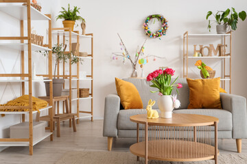 Interior of living room decorated for Easter with sofa and shelf units