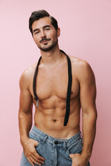 Fototapeta premium Man lifestyle pink belt naked torso fitness background muscle muscular sport body sexy